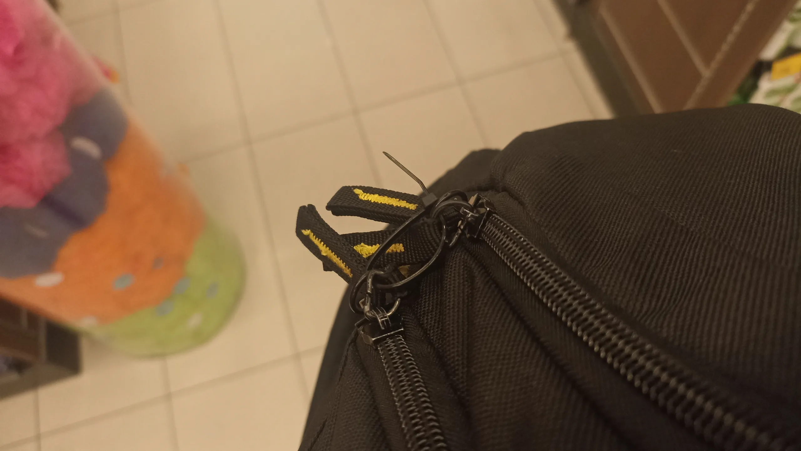 A backpack tied shut by a security guard in Kuala Lumpur, Malaysia to prevent shoplifting.